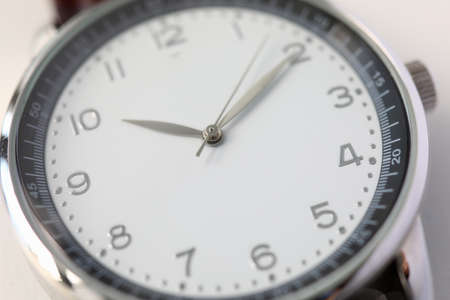 Close-up of luxury swiss fashion watches. Dial and arrows. Stylish men accessory wristwatch. Ten...