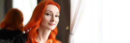 Young red-haired woman working out in a beauty salon. Portrait of a female professional spa employee