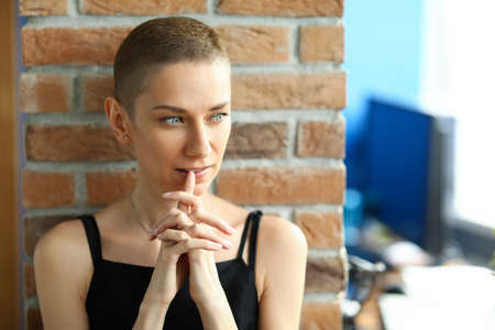 Portrait of pensive charming female looking away and posing for picture. Young lovely woman in black dress. Cute natural appearance and magnificent glance. Beauty conceptの写真素材