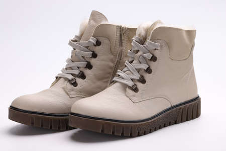 Beige winter boots with thick soles. Fashion trends in the shoe industry conceptの写真素材