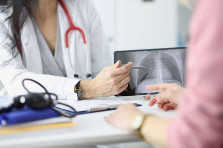 Doctor shows the patient an x-ray of lungs. Lung disease symptoms concept