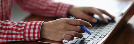 Female hands on laptop keyboard on desktop. Remote work concept
