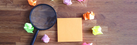 Magnifying glass and colored stickers on table. Search for new solutions for business concept