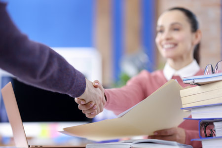 Handshake of man and woman in office closeup. Business agreement conceptの写真素材