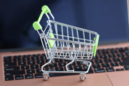 Shopping basket on the laptop keyboard. Online sales in online stores conceptの写真素材