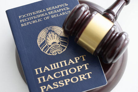 Wooden judges gavel and passport. Emigration to another country conceptの写真素材