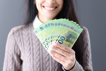Woman holding euro cash in her hands closeup. Successful business deals conceptの写真素材