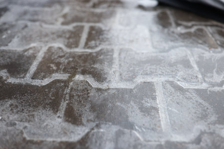 Road is covered with a thin layer of ice. Ice the injuryの写真素材