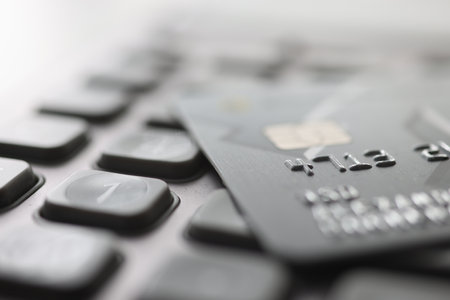 Bank plastic card lying on calculator closeup. Payment of taxes concept