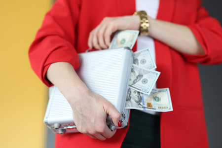 Woman is holding suitcase with lot of money. Successful gambling and betting concept