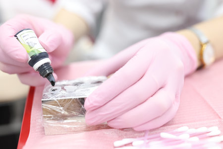 Artist adds ink to tattoo container. Permanent makeup material concept