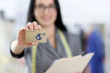 Credit bank plastic card in womans hand. Bank card payments conceptの写真素材