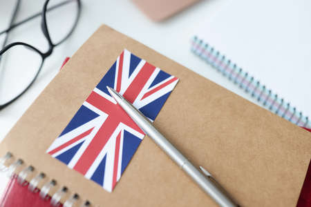 On table is diary with British flag and pen. Learning foreign languages from scratch conceptの写真素材