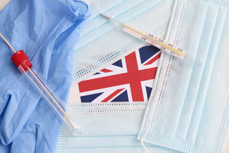 On table lies the British flag, medical protective masks and test for taking biological material. British virus strain conceptの写真素材