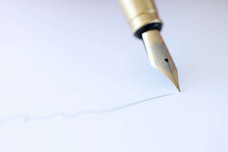 With fountain pen write on white sheet of paper. Signing contracts conceptの写真素材