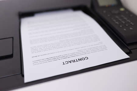 Contract document is printing on printer closeup. Employment conceptの写真素材