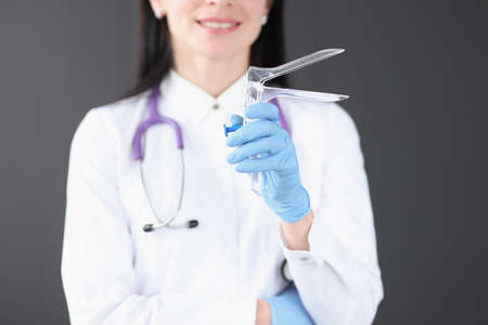 Gynecologist holding mirror instrument in his hands closeup. Gynecological examination conceptの写真素材