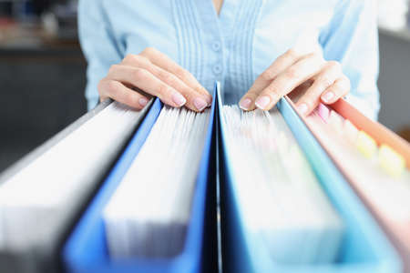 Womens hands on folders with documents. Business development strategy development concept