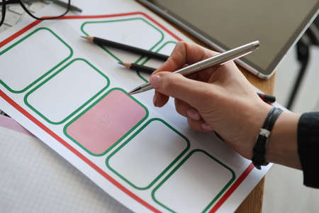 Womans hand puts mark in cadastral, map. Development and planning of plots for housing construction...