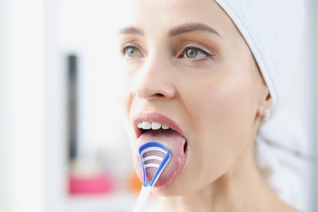 Woman cleans her tongue with special scraperの写真素材