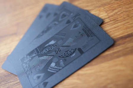 Black playing cards lie on table closeupの写真素材
