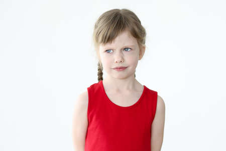 Portrait of sad little girl on white backgroundの写真素材