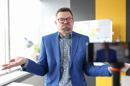 Emotional man shows gesture to camera closeupの写真素材