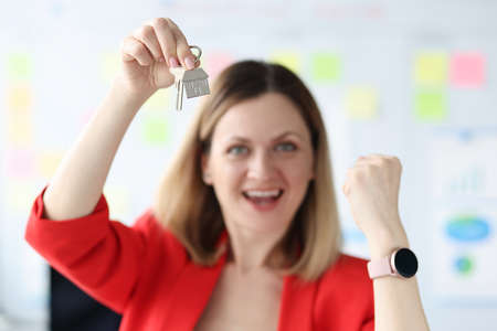 Happy smiling woman holding the keys to apartmentの写真素材