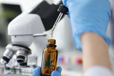 Lab is testing marijuana oil. Hemp oil - useful and dangerous propertiesの写真素材