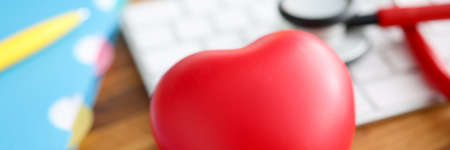 On table lies stethoscope red heart and keyboard.の写真素材
