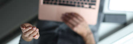 Woman waves her hand to laptop in greeting.の写真素材