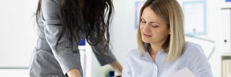 Businesswoman brought documents for signature to boss.の写真素材