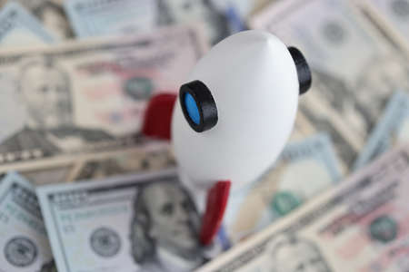 There are American bills and rocket on table.の写真素材