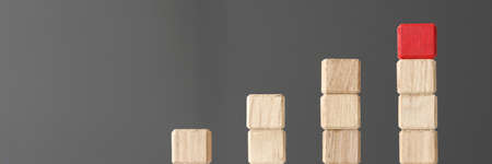 Wooden toy blocks stacked in shape of graphic