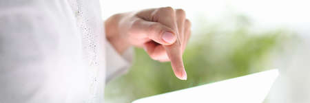 Business woman hands using digital tablet closeup