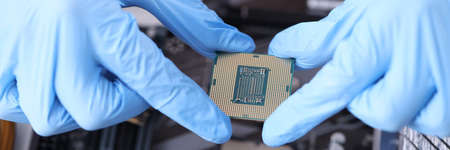 Master holds microcircuit over computer boards. Maintenance and service of computer equipment...