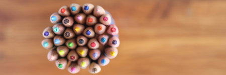 Many multicolored pencils on wooden background top viewの写真素材