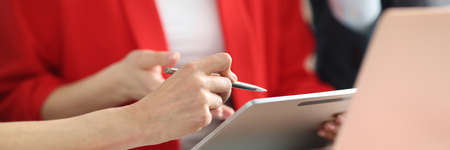 Group of business people are exploring data on tablet