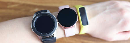 Three different wristwatches are wornning on womans hand closeupの写真素材