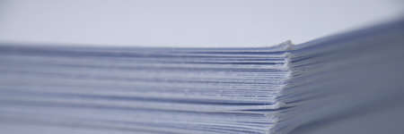 Large stack of white papers with reports