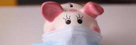 Ceramic piggy piggy bank in protective medical maskの写真素材