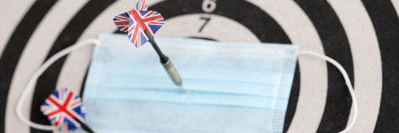 Protective medical mask attaching by arrow to target closeupの写真素材