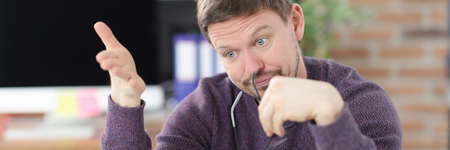 Surprised man looks at laptop screen in office