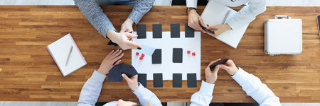 Group of people sitting at table and playing board games top view
