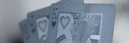 Man holding black playing cards in his hand closeupの写真素材