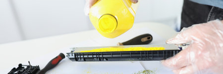 Master is pouring ink into cartridge for printer closeup