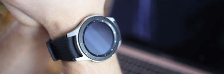 Smart watch is worn on mans hand