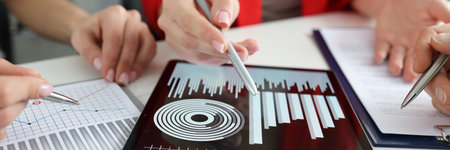 Discussion of financial and commercial indicators on tabletの写真素材
