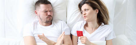 Man refusing to have sex with woman with condom top view