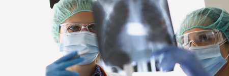 Doctors stand in the office and look at x-rays